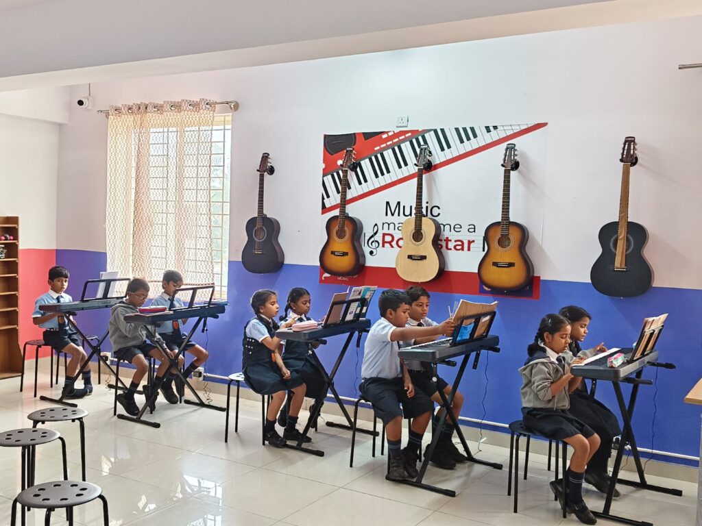 Students learning music in the music lab at Innovative School of Excellence, Horamavu